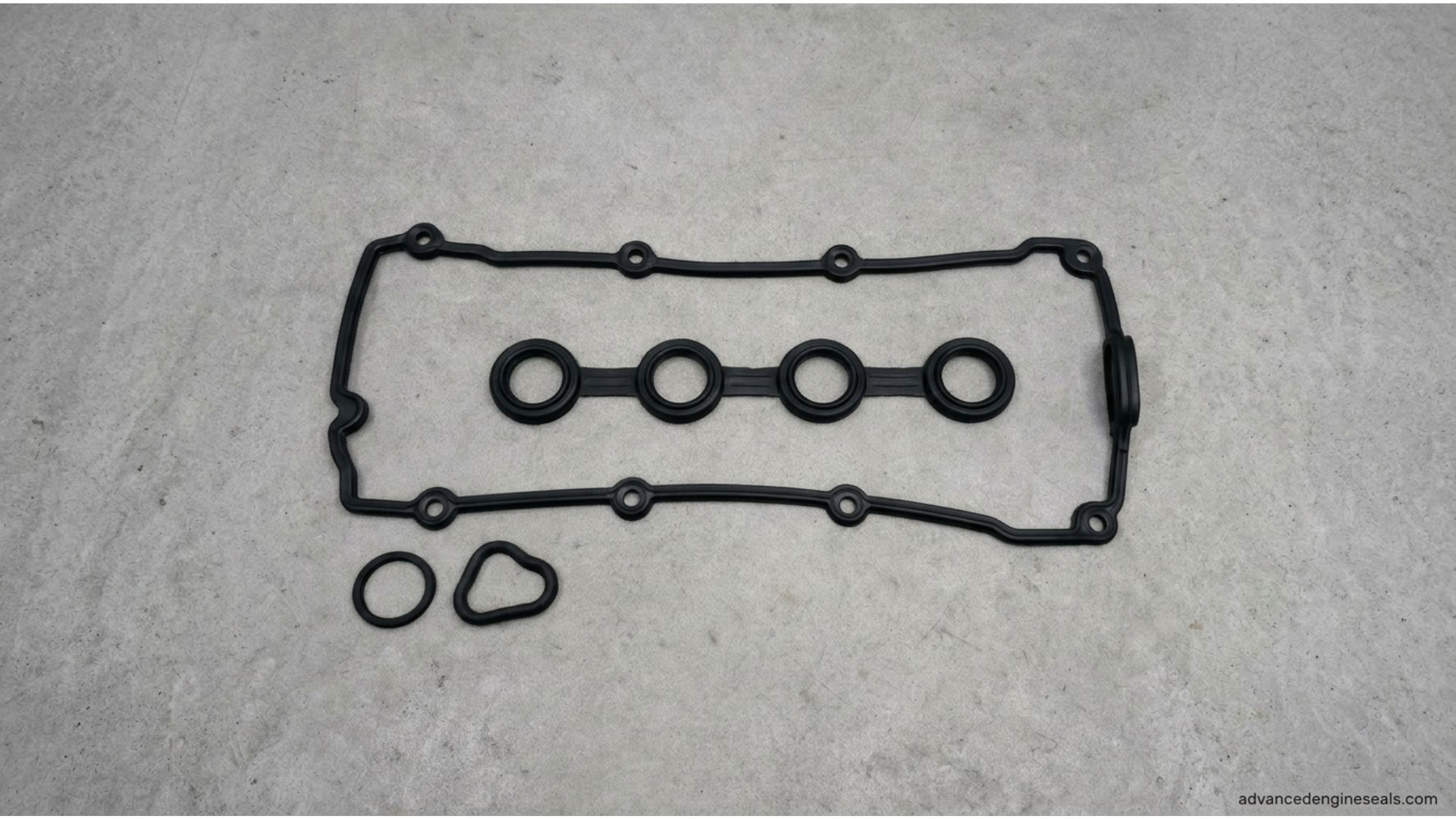 Close-up of a damaged valve cover gasket with oil leak on engine.